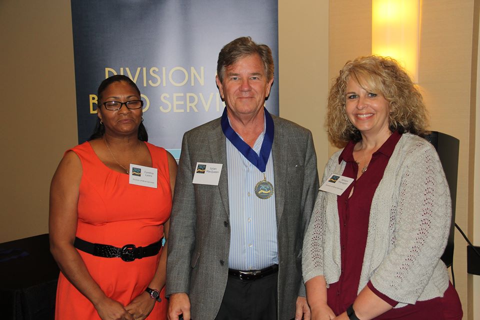 Innisfree CEO Julian MacQueen standing with DBS staff members Allison Flannigan and Cynthia Lyons during the Successful 75 Award presentation. 